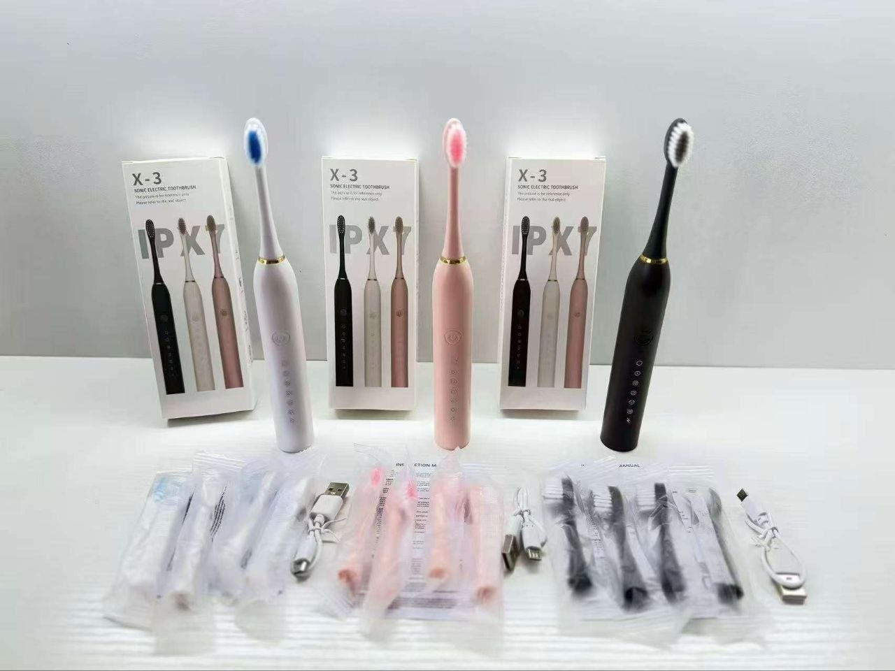 Electric toothbrush with three extra brush